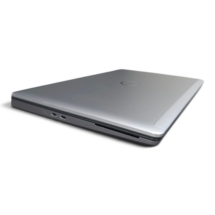 The Computer Market Dell Precision 7560 laptop in silver, shown from a closed side angle view.